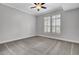 Cozy bedroom with neutral carpeting, plantation shutters, and a ceiling fan at 125 Pier View St # 209, Charleston, SC 29492