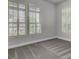 An empty bedroom with neutral walls, carpeted floors, and bright windows at 125 Pier View St # 209, Charleston, SC 29492