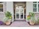 Inviting entrance to a residential building with double glass doors and attractive planters at 125 Pier View St # 209, Charleston, SC 29492