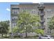 Exterior of a condo building with balconies, brick accents, and landscaping at 125 Pier View St # 209, Charleston, SC 29492