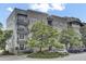 Condo building showcasing architectural details, balconies, and beautiful landscaping at 125 Pier View St # 209, Charleston, SC 29492