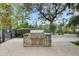 Outdoor BBQ grill with a stone base and a concrete patio at 125 Pier View St # 209, Charleston, SC 29492