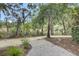 Walking path on manicured grounds with mature trees and shrubbery at 125 Pier View St # 209, Charleston, SC 29492