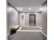 The lobby features carpet, bench seating, an elevator and an entrance door at 125 Pier View St # 209, Charleston, SC 29492
