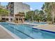 Outdoor swimming pool features a pergola, tanning areas, and community seating at 125 Pier View St # 209, Charleston, SC 29492
