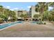 Enjoy the large swimming pool surrounded by palm trees and lounge chairs at 125 Pier View St # 209, Charleston, SC 29492