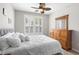 Bright bedroom featuring shuttered windows and a light ceiling fan complemented by wooden dresser at 130 River Landing Dr # 9104, Charleston, SC 29492