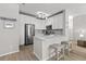 Modern kitchen with white cabinets, stainless steel appliances, gray backsplash, and a breakfast bar with seating at 130 River Landing Dr # 9104, Charleston, SC 29492