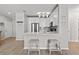 Modern kitchen with white cabinets, stainless steel appliances, gray backsplash, breakfast bar and stool seating at 130 River Landing Dr # 9104, Charleston, SC 29492