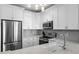 Well-lit kitchen featuring white cabinets, stainless steel appliances, and gray backsplash for a modern look at 130 River Landing Dr # 9104, Charleston, SC 29492