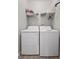 Functional laundry room equipped with a washer and dryer, plus additional overhead shelving for storage at 130 River Landing Dr # 9104, Charleston, SC 29492