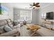 Comfortable living room with a large couch, beach themed accents, hardwood floors and an entertainment center at 130 River Landing Dr # 9104, Charleston, SC 29492