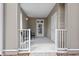 Covered patio featuring stylish chairs with cushions, a white railing, and a welcoming entrance at 130 River Landing Dr # 9104, Charleston, SC 29492