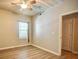 A bright bedroom featuring neutral walls, wood-look flooring, a ceiling fan, and a window at 1300 Park West Blvd # 519, Mount Pleasant, SC 29466