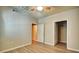 A bright bedroom featuring neutral walls, wood-look flooring, a ceiling fan, and two open doors at 1300 Park West Blvd # 519, Mount Pleasant, SC 29466