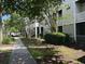 Exterior shot of the apartment building with green landscaping and a sidewalk at 1300 Park West Blvd # 519, Mount Pleasant, SC 29466