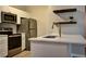 Stylish kitchen with stainless steel appliances, a modern island and decorative shelves at 1300 Park West Blvd # 519, Mount Pleasant, SC 29466