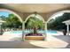 Lounge at the pool beneath the shade in this outdoor living space with palm trees at 1300 Park West Blvd # 519, Mount Pleasant, SC 29466