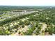 Expansive aerial view showcasing a vibrant residential neighborhood with lush greenery, a lake, and well-maintained streets at 1304 Pinyon Pine Dr, Ladson, SC 29456