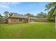 Spacious backyard featuring brick home, green lawn, patio and fencing at 1304 Pinyon Pine Dr, Ladson, SC 29456
