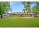 Spacious backyard featuring lush green lawn, brick patio, and storage shed at 1304 Pinyon Pine Dr, Ladson, SC 29456