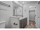 Bathroom featuring double sink vanity, framed mirror and adjacent closet at 1304 Pinyon Pine Dr, Ladson, SC 29456