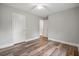 Bright bedroom offers wood-look flooring, base trim, and paneled doors at 1304 Pinyon Pine Dr, Ladson, SC 29456