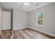 Bedroom showcasing a ceiling fan, window, and door against neutral walls at 1304 Pinyon Pine Dr, Ladson, SC 29456