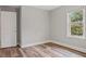 Bright bedroom features a window with outdoor view and wood-look flooring at 1304 Pinyon Pine Dr, Ladson, SC 29456