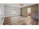 Spacious bedroom with wood-look flooring, wood accent wall and ensuite bathroom at 1304 Pinyon Pine Dr, Ladson, SC 29456