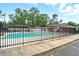 Close-up of the community pool, complete with fencing, lounge chairs, and clear blue water for relaxation and enjoyment at 1304 Pinyon Pine Dr, Ladson, SC 29456
