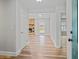 Open entryway featuring hardwood floors, a stone fireplace, and great natural light at 1304 Pinyon Pine Dr, Ladson, SC 29456