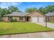 Charming brick home featuring a well-manicured lawn and a two-car garage at 1304 Pinyon Pine Dr, Ladson, SC 29456