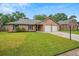 Beautiful brick home featuring a lush green lawn and a spacious two-car garage at 1304 Pinyon Pine Dr, Ladson, SC 29456