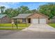 Lovely single-story home with brick exterior, green lawn and two-car garage at 1304 Pinyon Pine Dr, Ladson, SC 29456