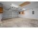 Spacious garage featuring concrete flooring and overhead door with opener at 1304 Pinyon Pine Dr, Ladson, SC 29456