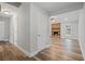 Inviting hallway leading to a living area with a stone fireplace and bright window at 1304 Pinyon Pine Dr, Ladson, SC 29456