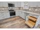 Bright kitchen featuring stainless appliances, light granite countertops, and functional roll-out drawers at 1304 Pinyon Pine Dr, Ladson, SC 29456