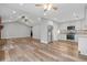 Hardwood floors continue into a pristine kitchen with stainless steel appliances at 1304 Pinyon Pine Dr, Ladson, SC 29456