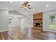Open floor plan with hardwood floors, stone fireplace, leading to patio doors at 1304 Pinyon Pine Dr, Ladson, SC 29456