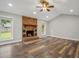 Cozy living room featuring hardwood floors, a stone fireplace, and natural light at 1304 Pinyon Pine Dr, Ladson, SC 29456