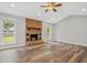 Inviting living room showcasing hardwood floors, stone fireplace, and natural light at 1304 Pinyon Pine Dr, Ladson, SC 29456