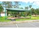 Community playground featuring a shaded play structure, swings, and picnic tables for entertainment at 1304 Pinyon Pine Dr, Ladson, SC 29456