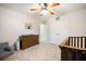 Bedroom featuring a crib, dresser and comfortable chair, creating a warm space at 1309 Belgian Draft Dr, Mount Pleasant, SC 29466