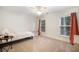 Bright bedroom features neutral carpet, a ceiling fan, and two windows with natural light at 1309 Belgian Draft Dr, Mount Pleasant, SC 29466