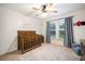 Well-lit Bedroom with hardwood crib, ceiling fan, and bright window at 1309 Belgian Draft Dr, Mount Pleasant, SC 29466