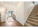 Light-filled entryway with hardwood floors, staircase, and view of the front door at 1309 Belgian Draft Dr, Mount Pleasant, SC 29466