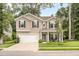 Charming two-story home with manicured lawn, attached two-car garage and welcoming front porch with a bench at 1309 Belgian Draft Dr, Mount Pleasant, SC 29466