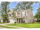 Traditional two-story home with a well-maintained lawn, attached garage, and welcoming front porch at 1309 Belgian Draft Dr, Mount Pleasant, SC 29466