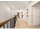 Upstairs hallway with neutral carpet and wood railing at 1309 Belgian Draft Dr, Mount Pleasant, SC 29466